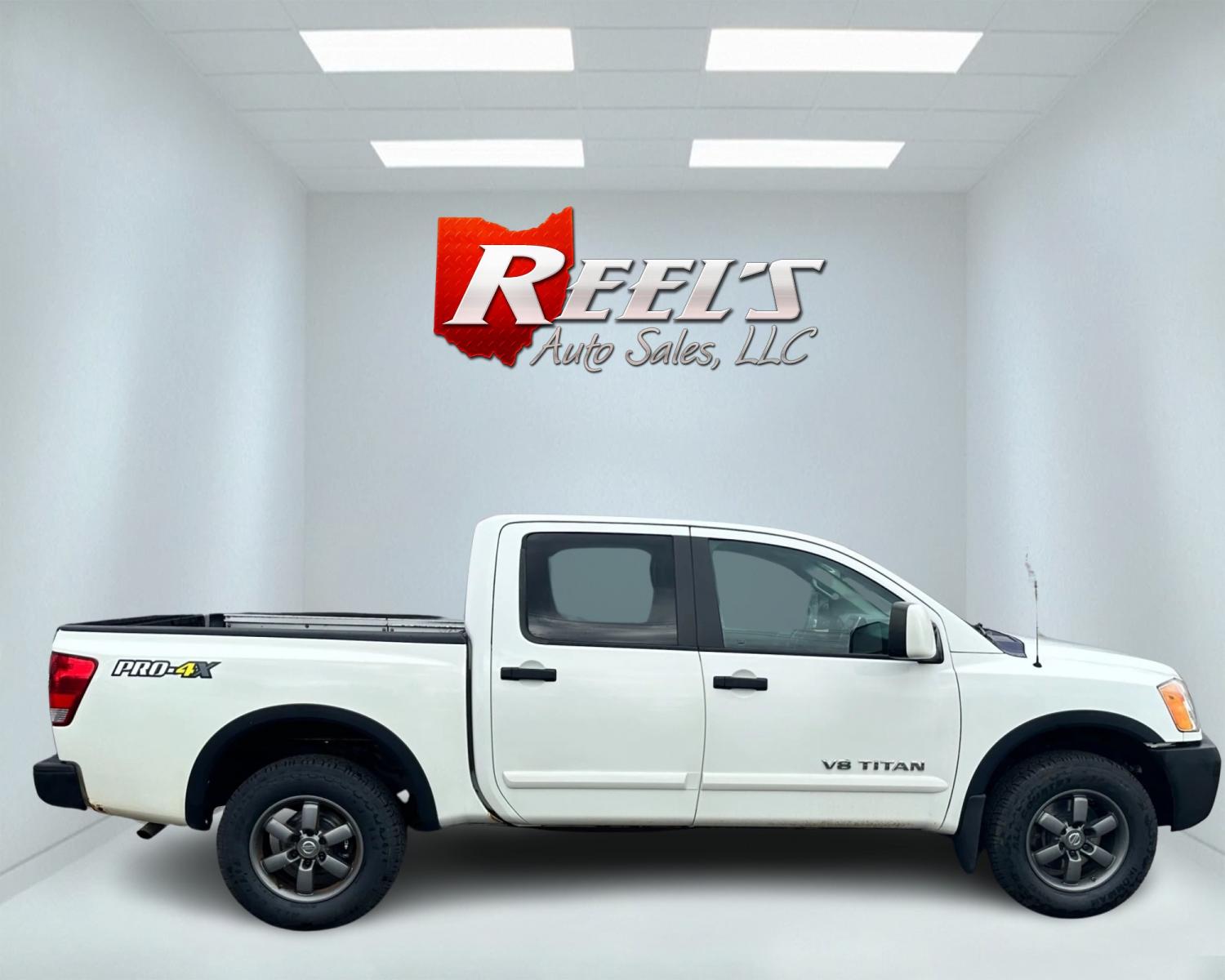 2013 White /Black Nissan Titan Pro-4X (1N6AA0EC0DN) with an 5.6L DOHC 32V V8 engine, Automatic transmission, located at 547 E. Main St., Orwell, OH, 44076, (440) 437-5893, 41.535435, -80.847855 - This 2013 Nissan Titan Pro-4X Crew Cab is a capable and well-equipped full-size pickup truck. It features a powerful 5.6L Endurance V8 engine paired with a 5-speed automatic transmission, a locking rear differential for improved traction, and a maximum towing capacity of 9,300 pounds. The truck is l - Photo #3